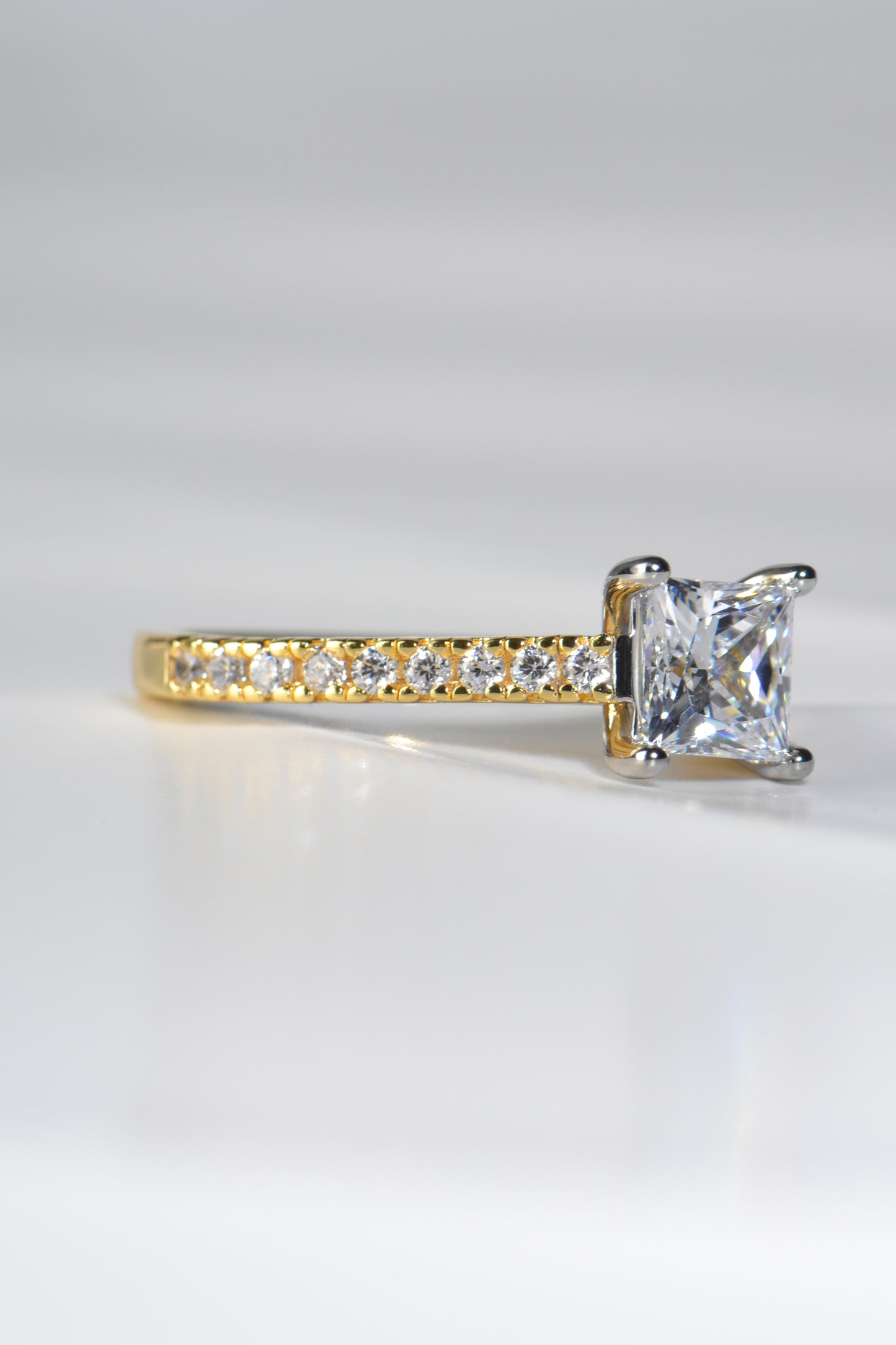 modern two tone princess cut diamond engagement ring with diamonds in the shoulders, made in the uk