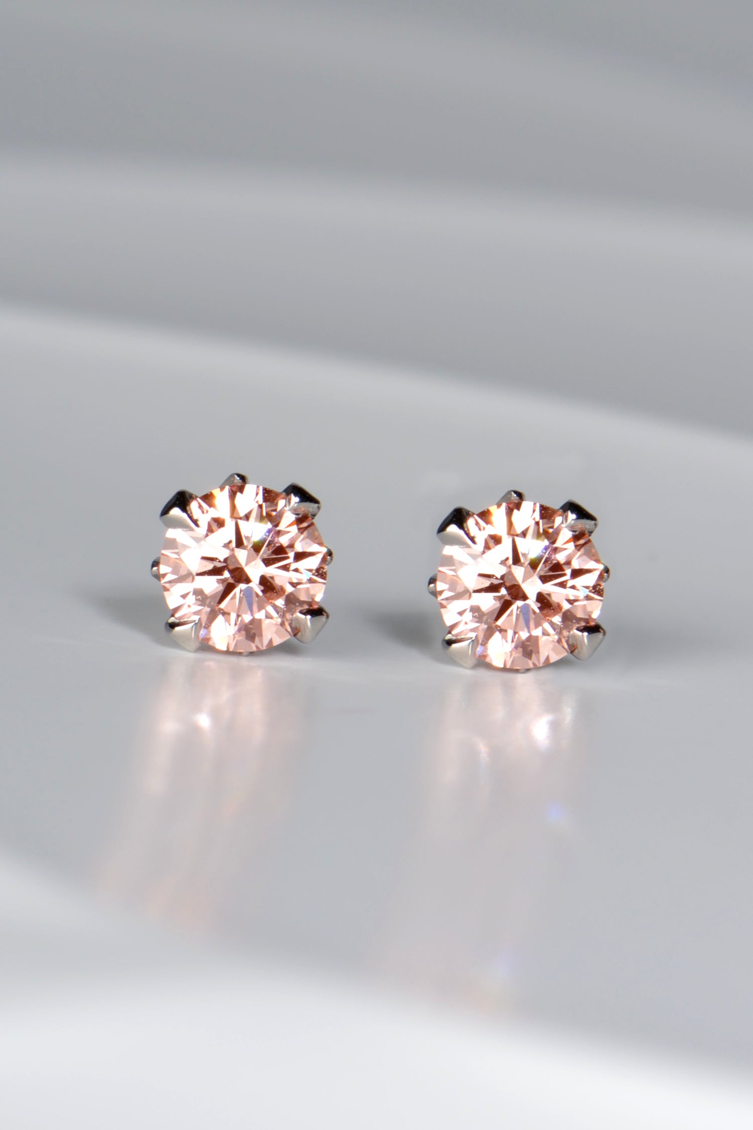 Fancy vivid pink certificated platinum lab diamond earrings. An exclusive design by UK jewellery designer Christine Sadler.