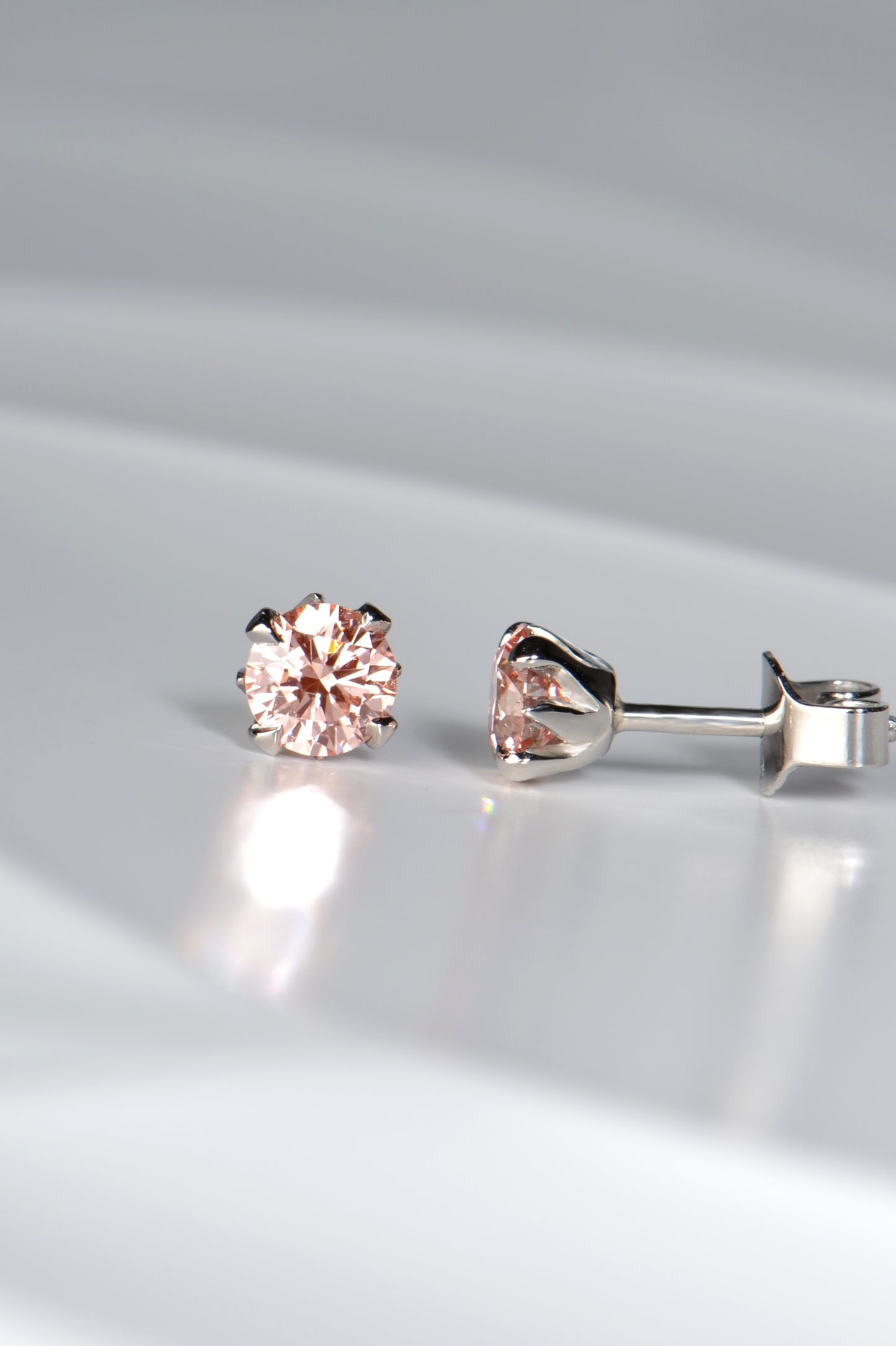 certificated pink lab diamond earrings with tiny flames of platinum that hold the gemstones exclusively available from designer Christine Sadler