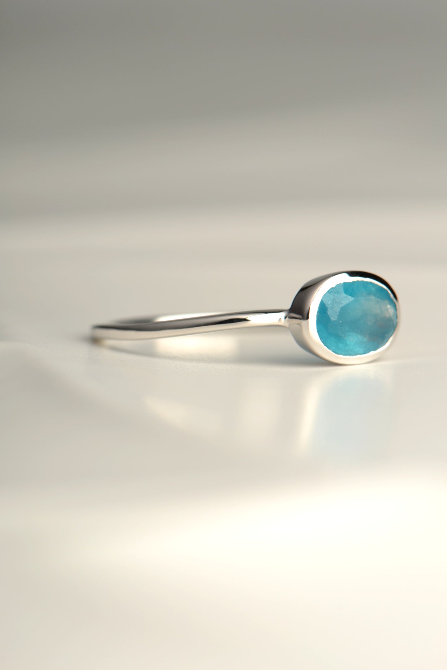 slim silver ring with an oval apatite gemstone from jewellery designer Jorge Revilla