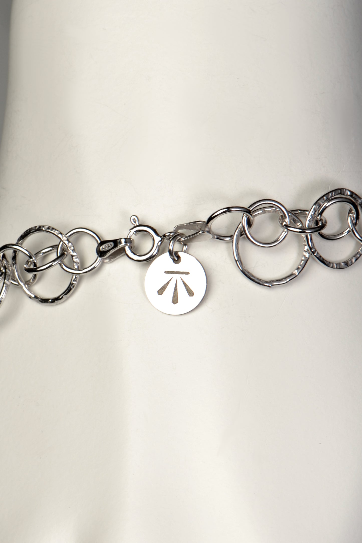 silver circle bracelet with branded tag and clasp - Christine Sadler