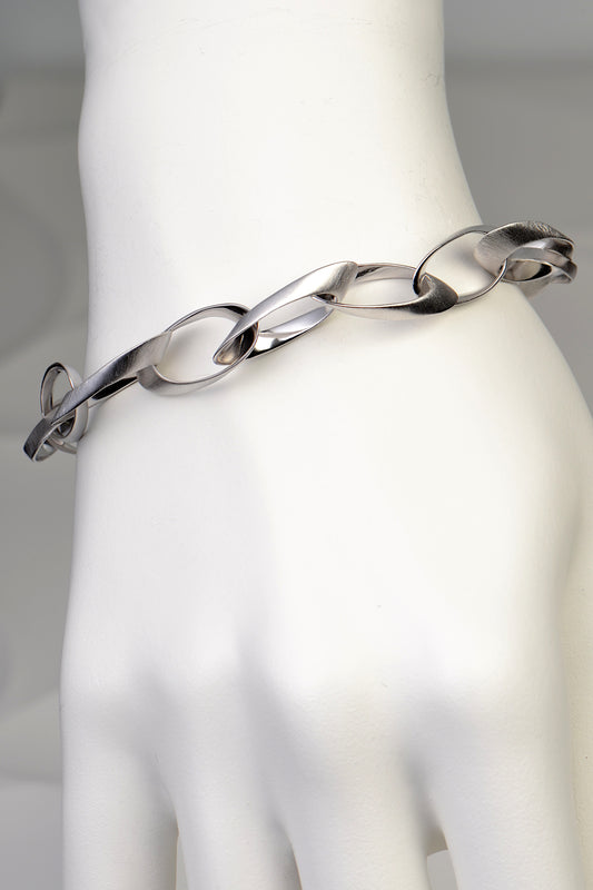 oval sculptural link sterling silver designer bracelet that looks like Christmas paper garlands. Really different and special design from Jorge Revilla