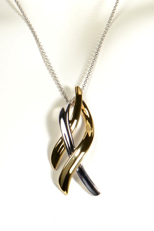 three strands of silver and gold vermeil make up a large designer pendant design that looks like ribbons blowing in the wind on a 45cm long silver chain