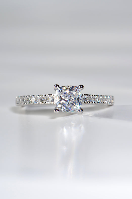 cushion cut platinum diamond engagement ring with diamonds in the shoulders made in the UK