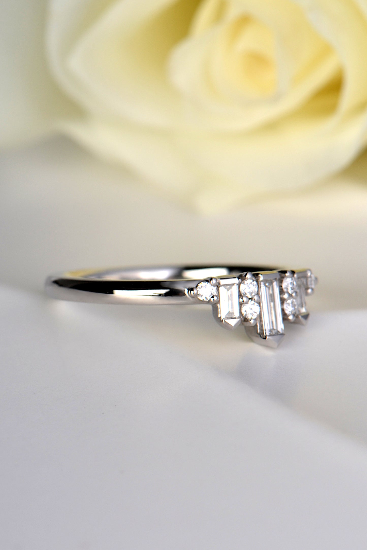 platinum and diamond ring that has a narrow band three quarters of the way round before it meets the diamonds at the front where it gets wider to 4.5mm. 