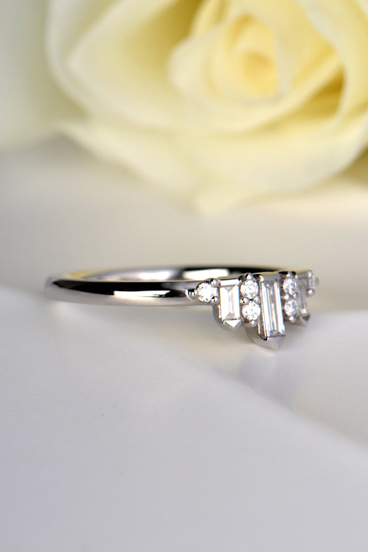 platinum and diamond ring that has a narrow band three quarters of the way round before it meets the diamonds at the front where it gets wider to 4.5mm. 