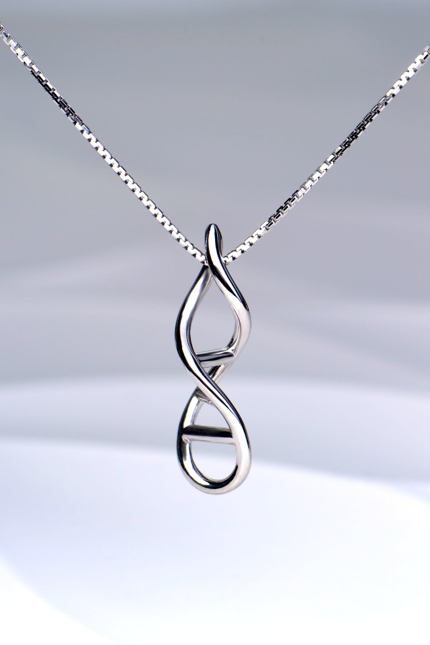 silver designer necklace in the shape of a DNA double helix twisted ladder, exclusively available from Christine Sadler