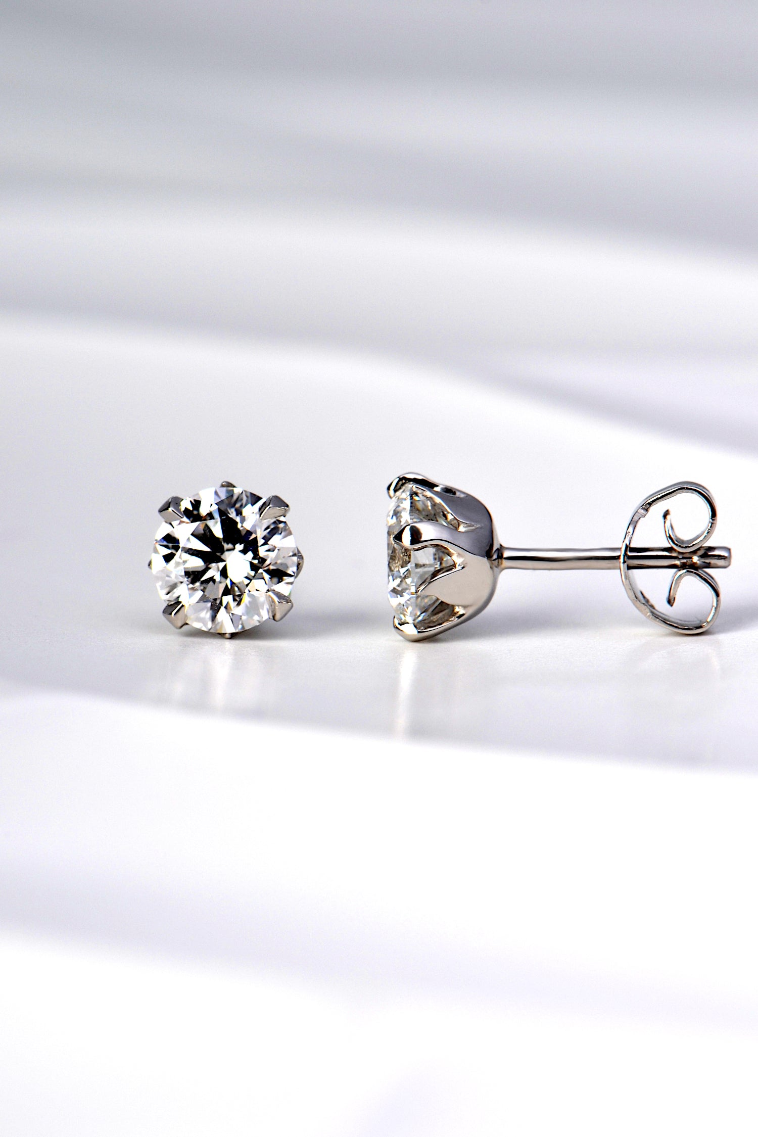 tiny platinum flame two carat lab diamond earrings exclusively available from Christine Sadler