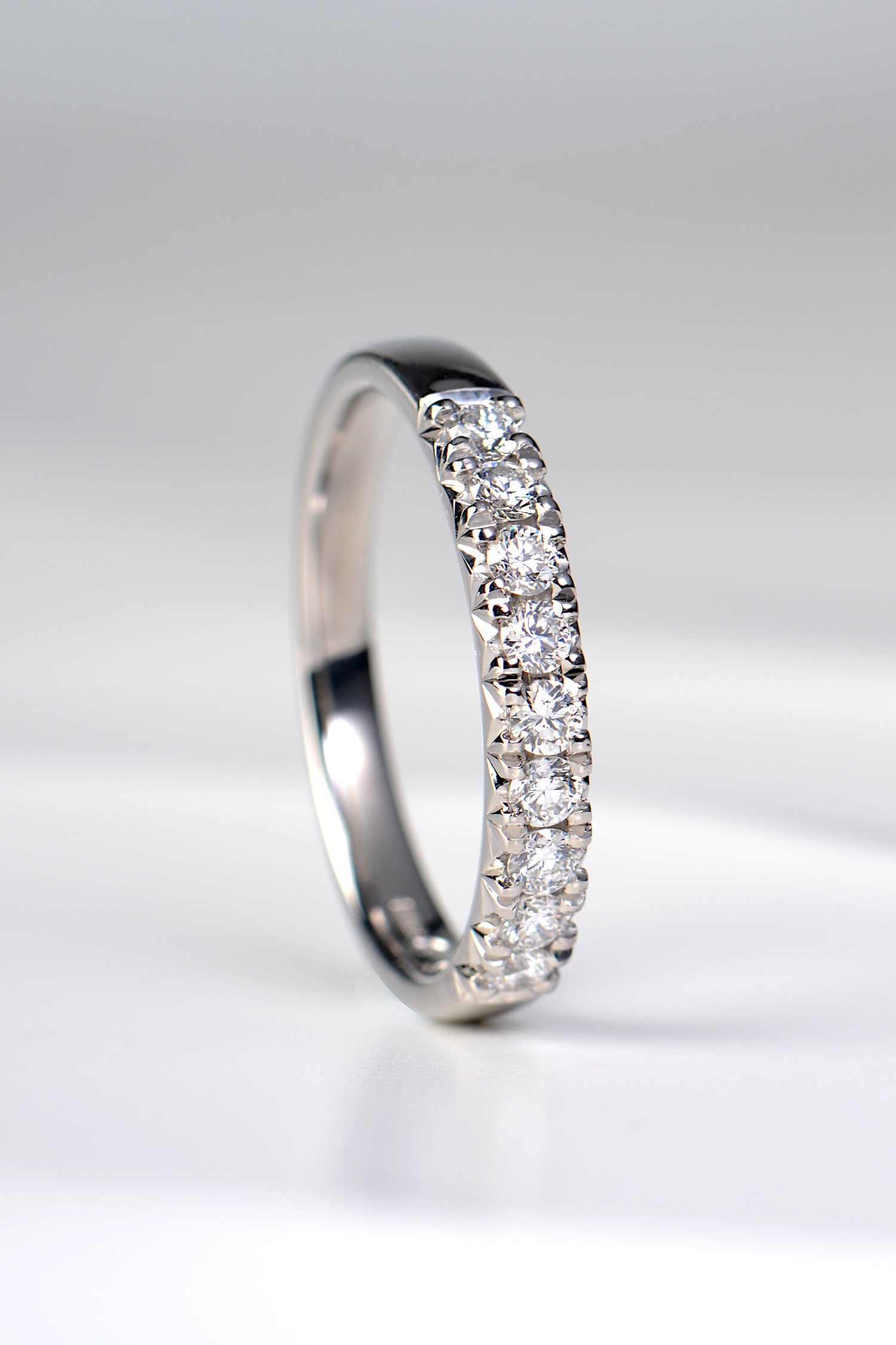 modern platinum diamond set band with nine round diamonds, handmade in the UK