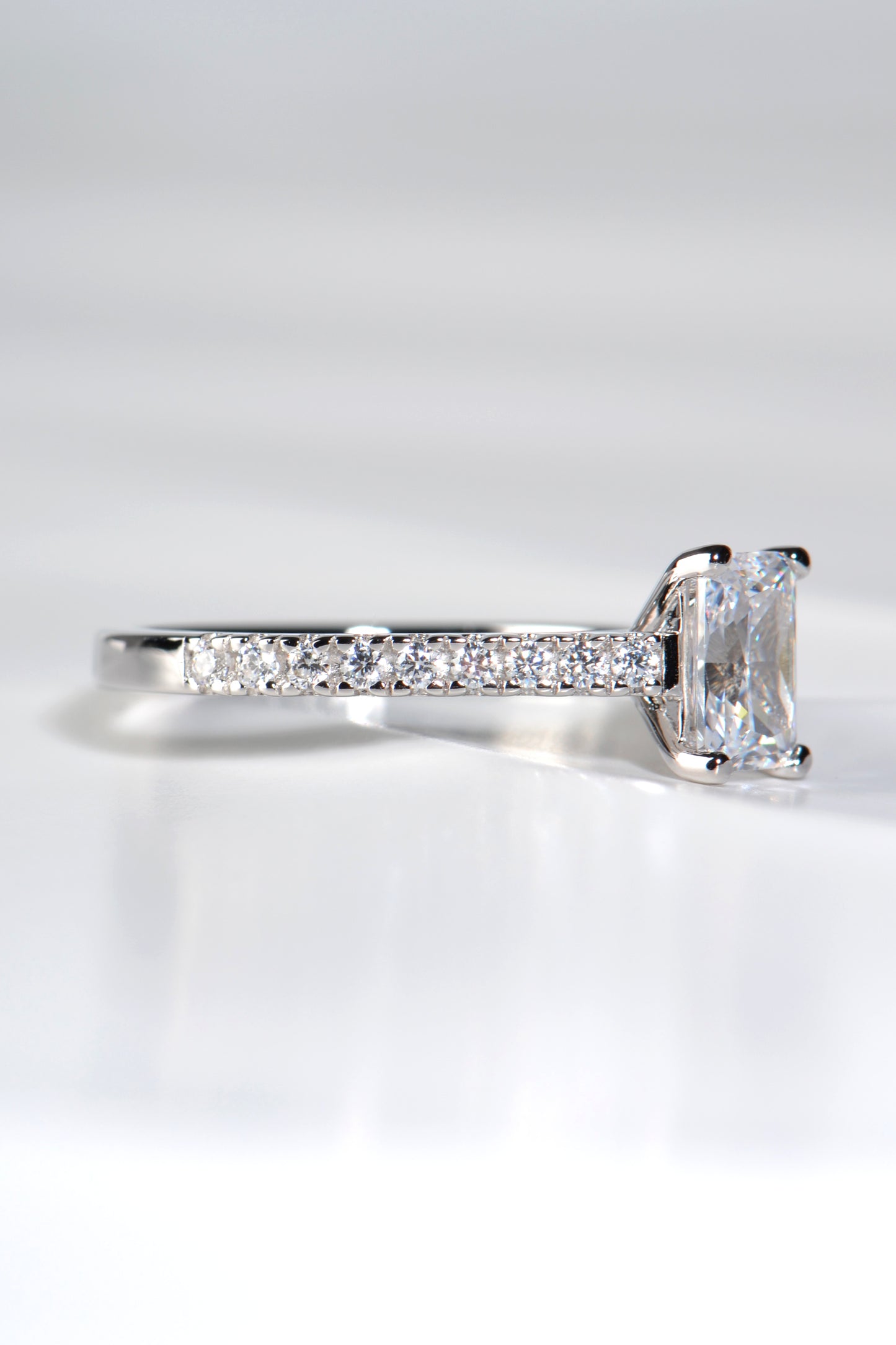 diamond set shoulders of emerald cut diamond engagement ring made in the UK