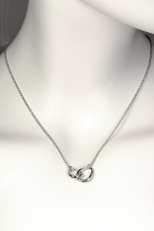 interlocking silver necklace with two oval egg shaped links at the front, one larger and one smaller, on a fine silver chain. Part of Christine Sadler's Faith collection