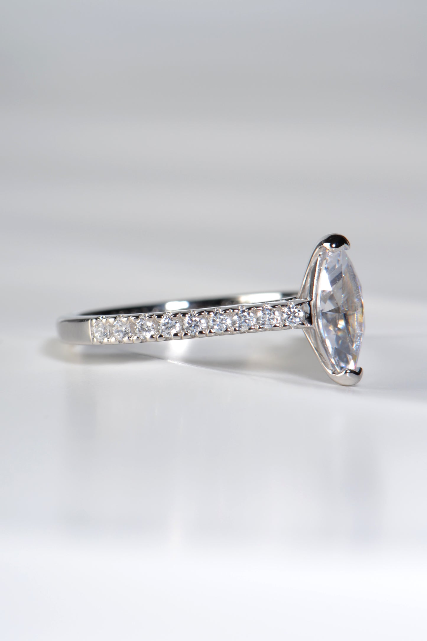 diamond set shoulders of platinum engagement ring with a marquise cut  centre stone