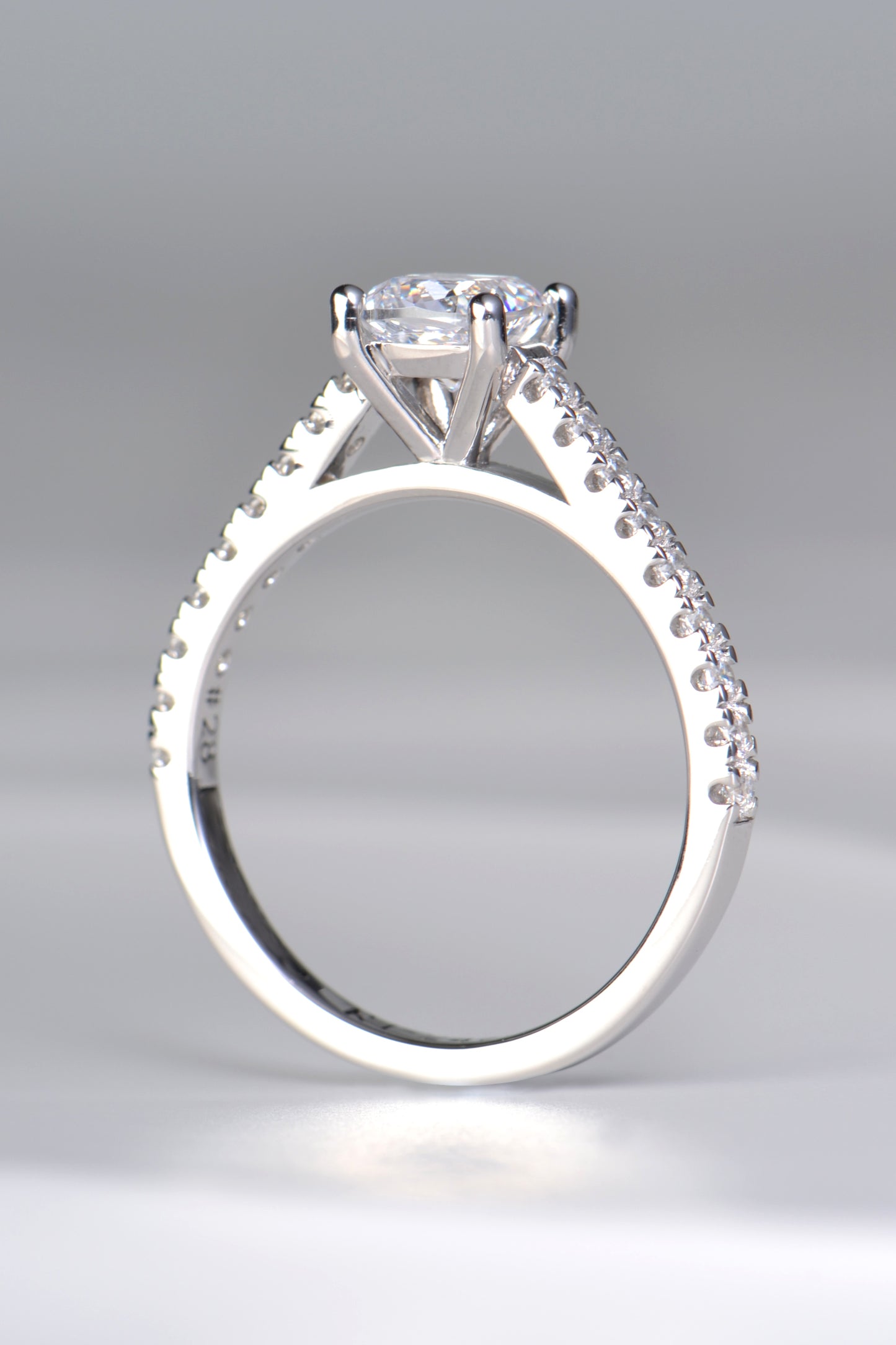 contemporary platinum designer engagement ring with a cushion cut diamond and diamond set shoulders