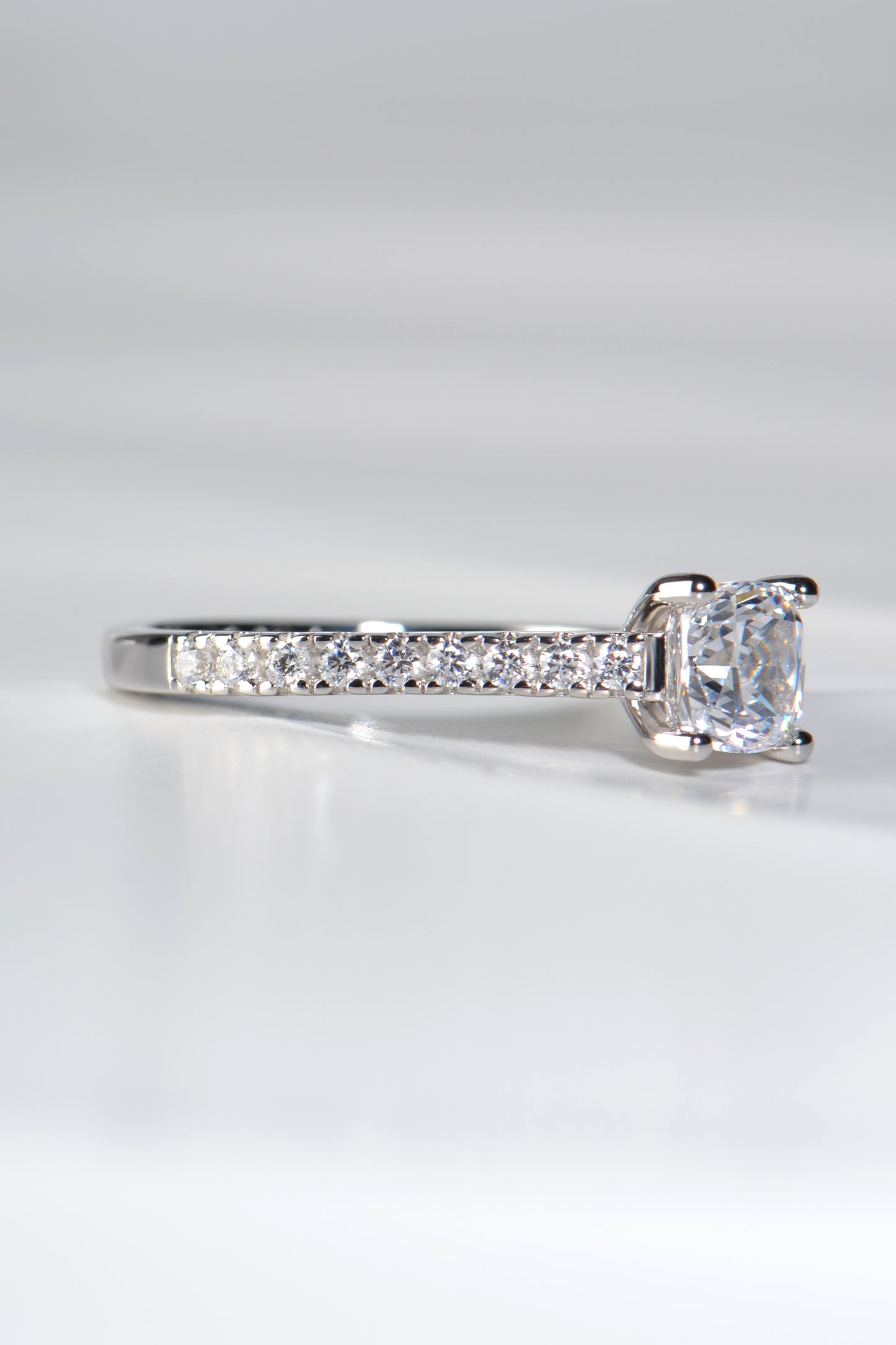 modern engagement ring with diamonds in the shoulders made in the UK