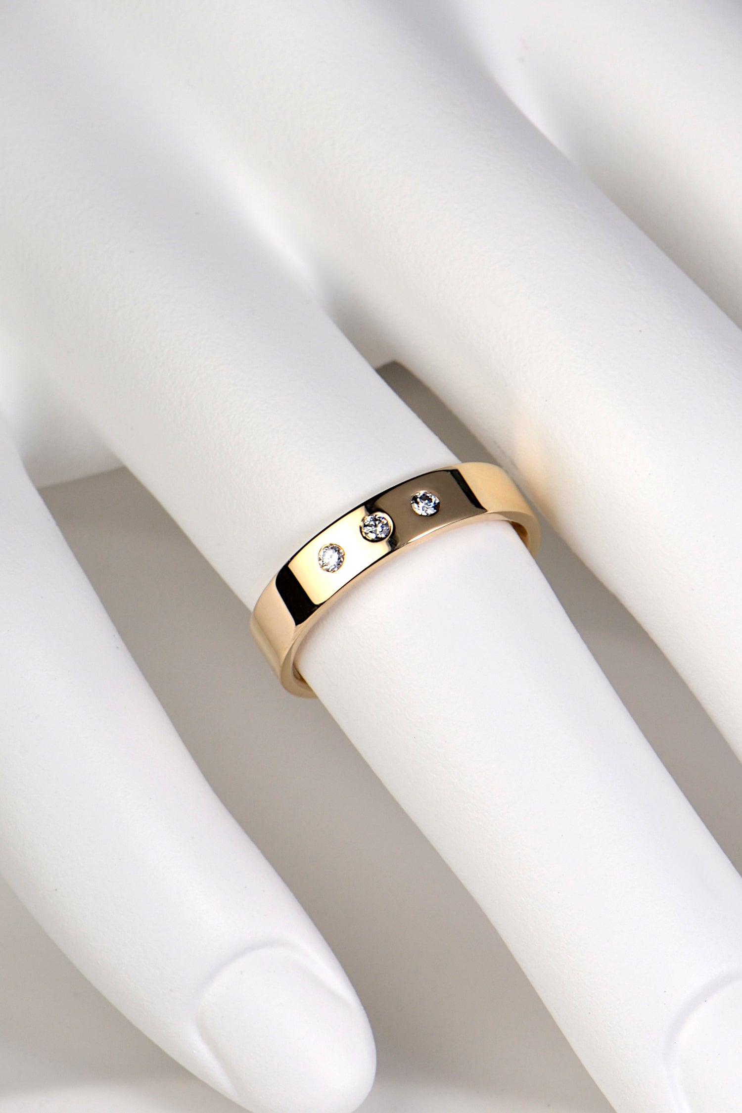 4mm wide modern yellow gold wedding ring with three diamonds for a man or woman