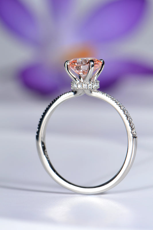 modern pink lab diamond with a halo of diamonds below the stone. This platinum engagement ring is handmade in the UK