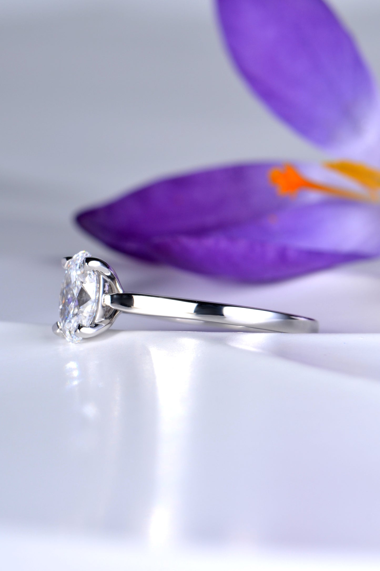 simple four claw oval cut diamond platinum engagement ring