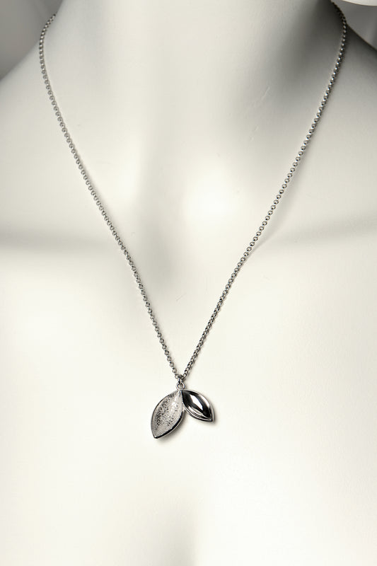 modern sterling silver handmade necklace with two concave seed shapes, one textured and one polished. This necklace is called The Promise because a tree is planted in Scotland for each one sold - Christine Sadler