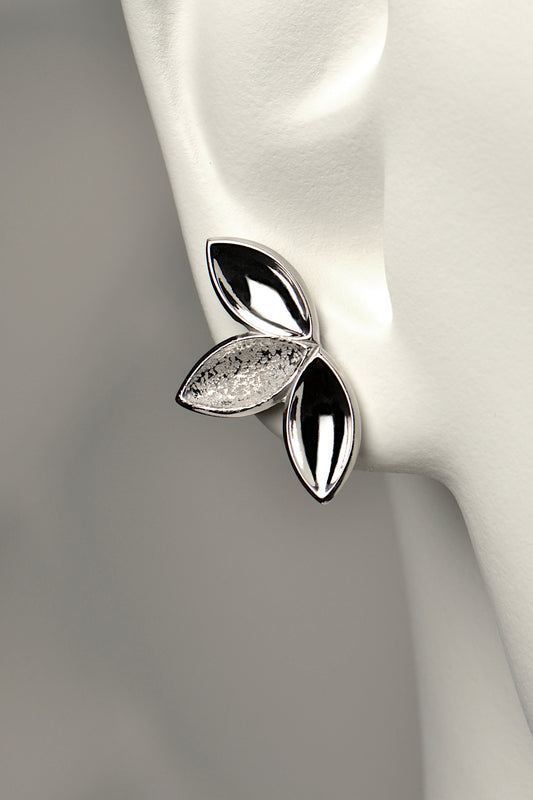 fairy like large silver stud earring made of three concave seed pod shapes in highly polished and contrasting modern textured finishes. The Promise jewellery collection from Christine Sadler plants a tree for every piece sold.