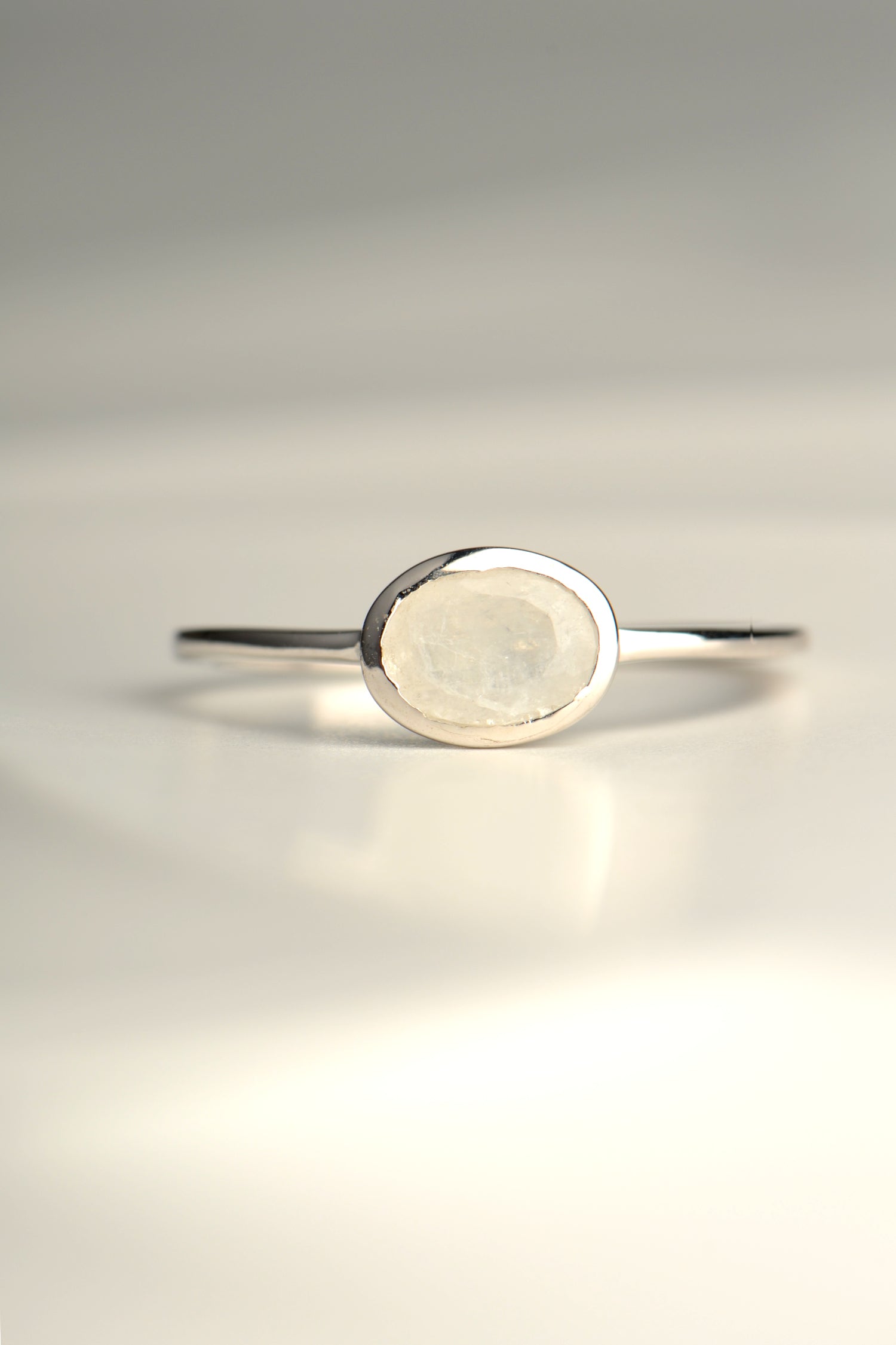 oval rainbow moonstone designer silver ring that is slim and delicate for a girl or woman from jewellery designer Jorge Revilla