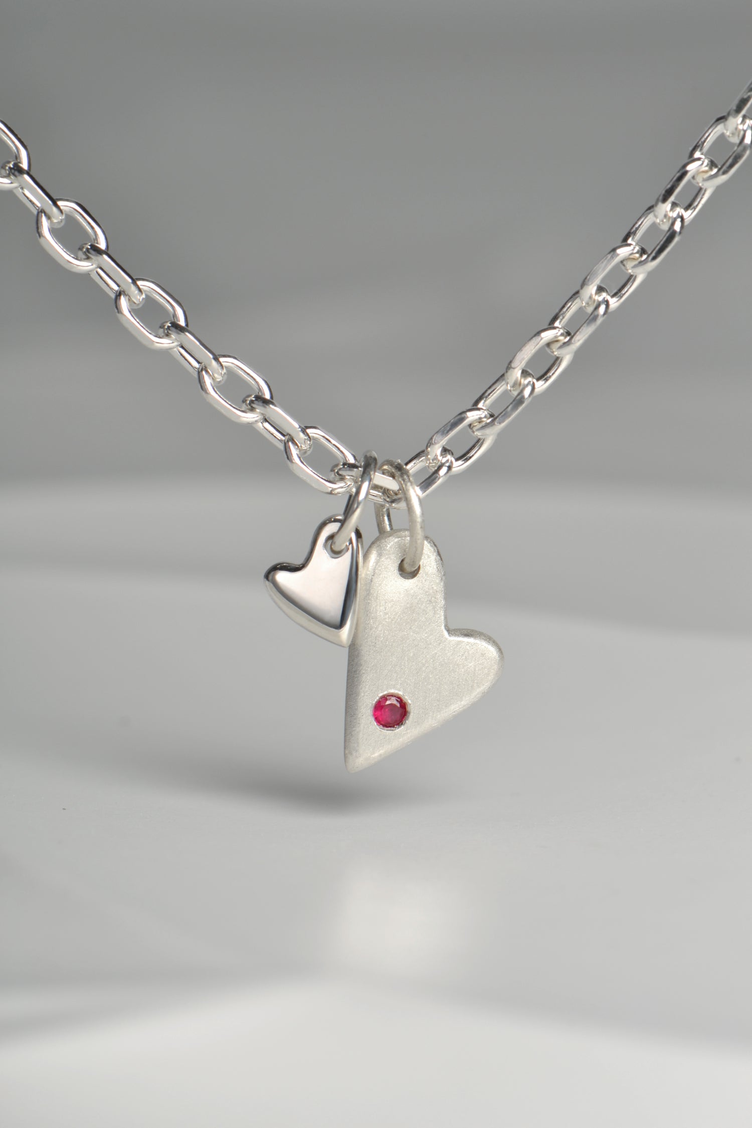 sterling silver handmade designer heart necklace set with a ruby