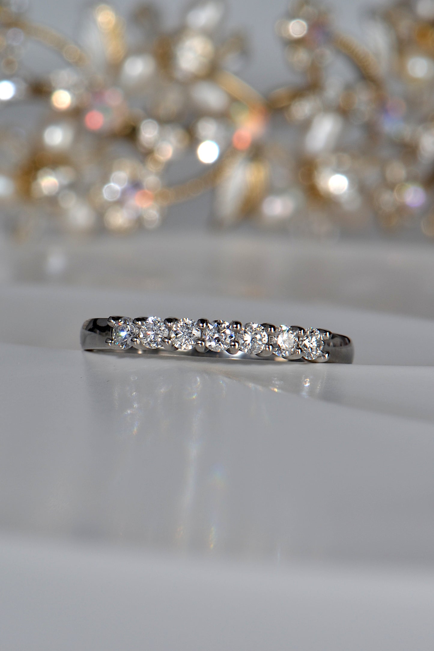 narrow platinum wedding ring set with seven round brilliant cut diamonds that have tremendous sparkle