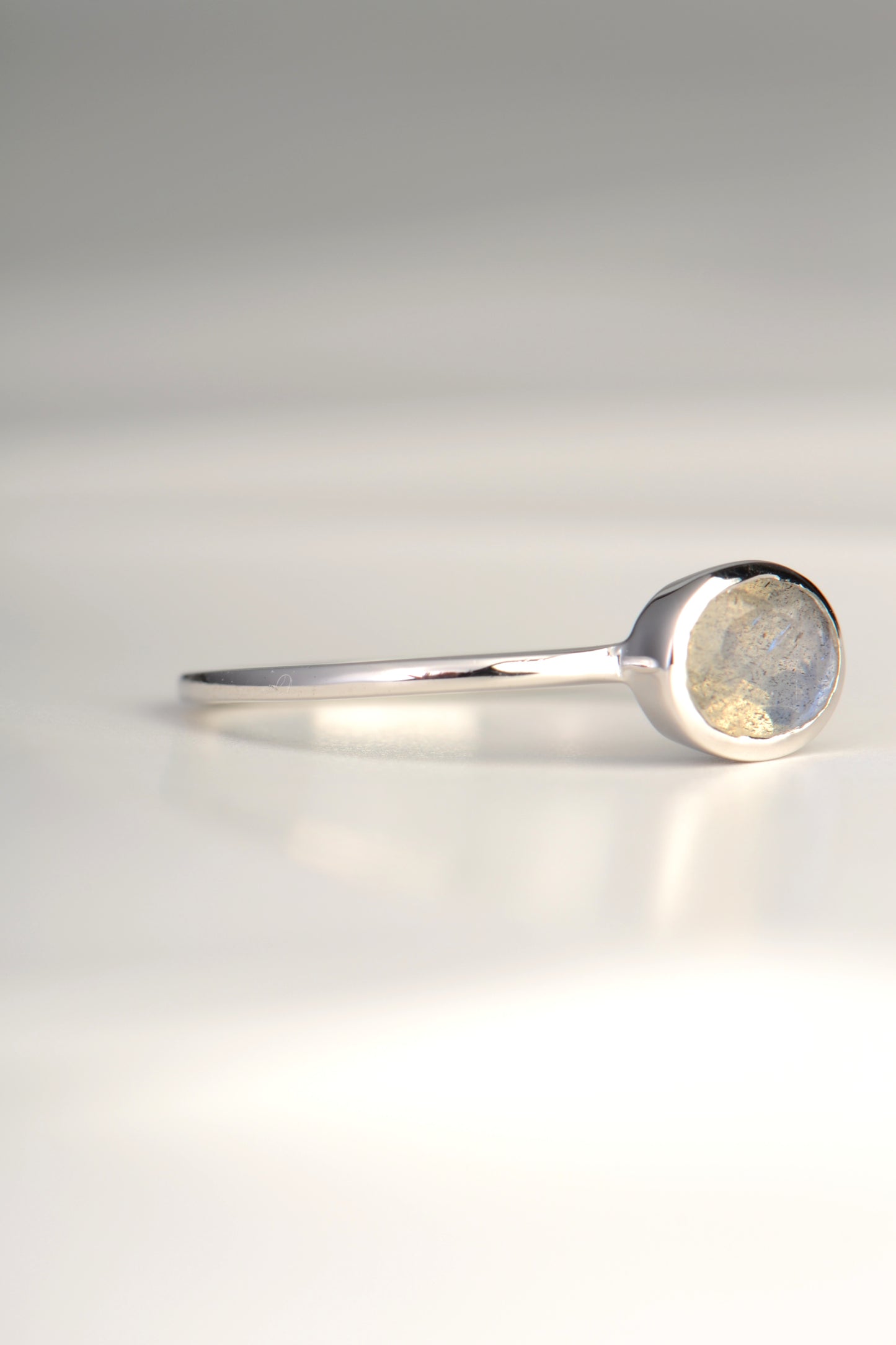 slim silver gemstone ring set with an oval Labradorite which is a grey gemstone from jewellery designer Jorge Revilla