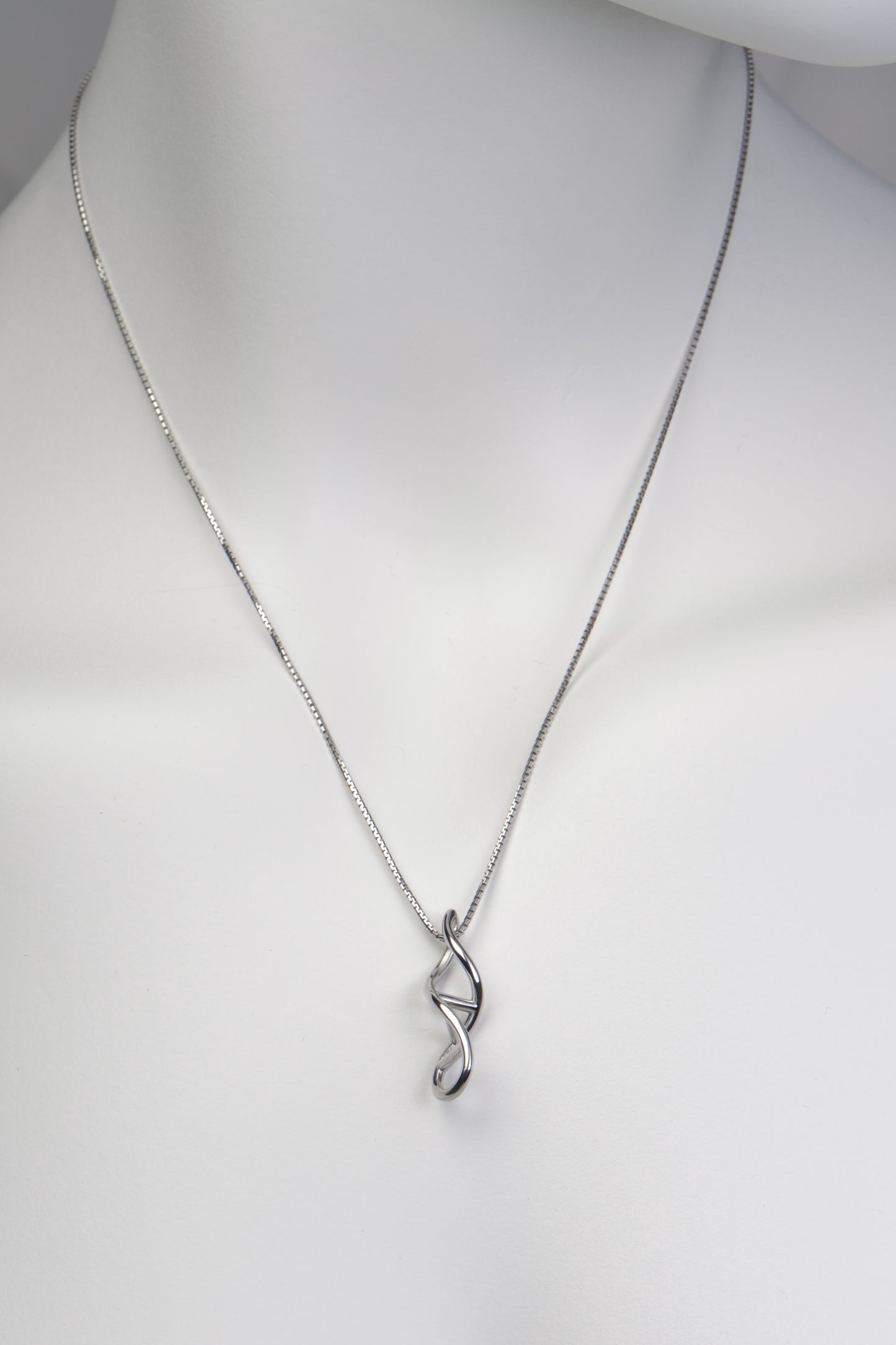 silver pendant designed for a family member, in the shape of a dna double helix twisted ladder exclusively available from jewellery designer Christine Sadler