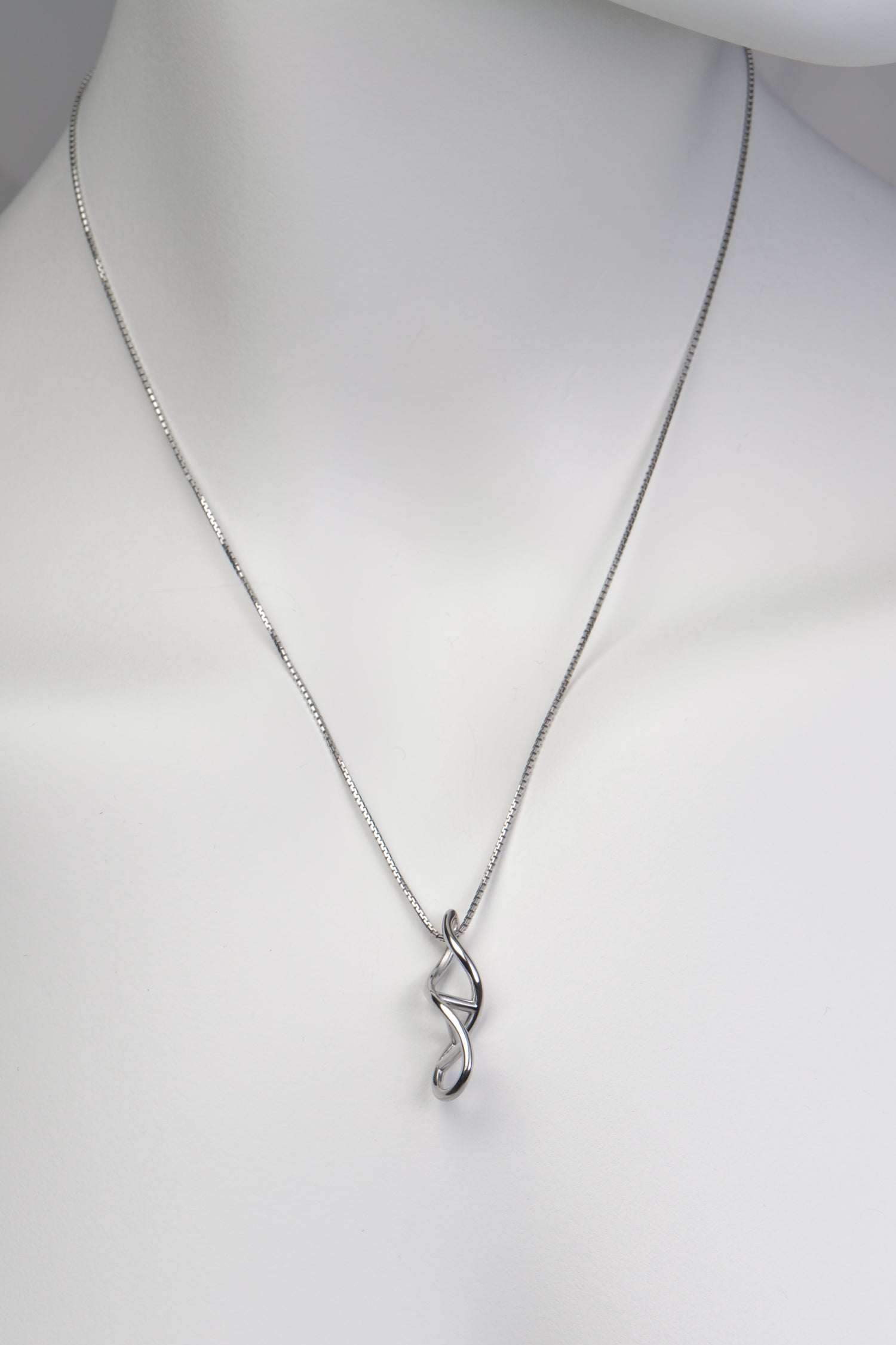 silver pendant designed for a family member, in the shape of a dna double helix twisted ladder exclusively available from jewellery designer Christine Sadler