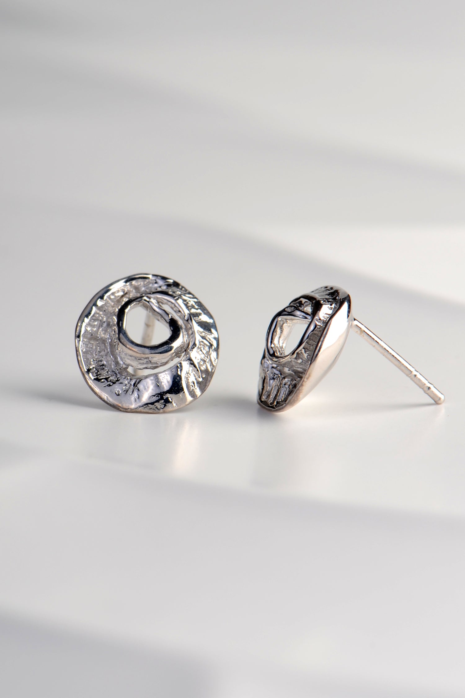 small circular stud earrings with ridged texture inspired by seaweed