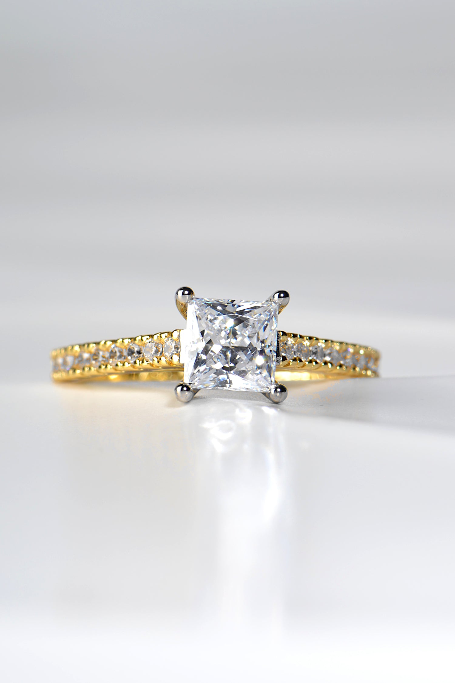 yellow gold princess cut diamond engagement ring with a platinum four claw setting, made in the UK