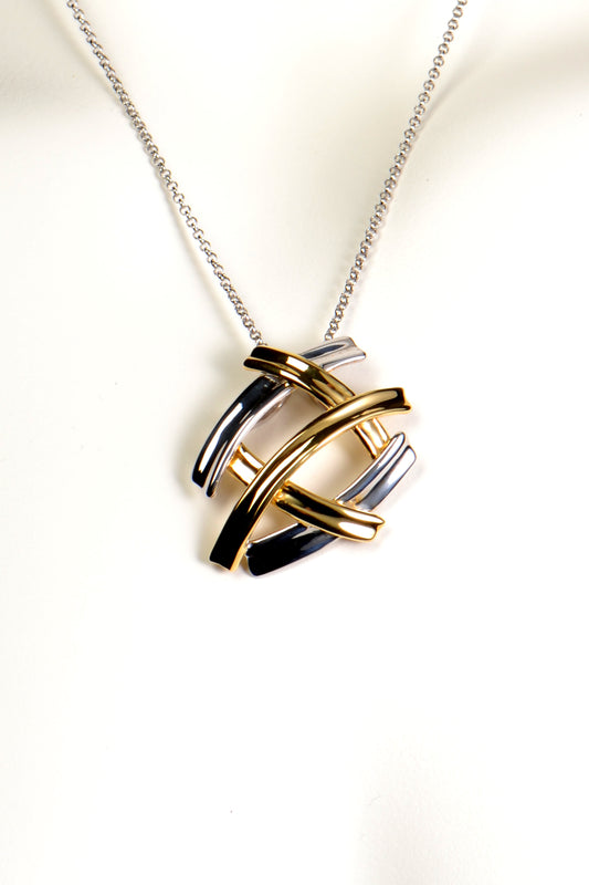 A modern designer pendant with five bars of silver that criss cross in a kiss design. Three of the silver bars have 18ct gold vermeil. The pendant hangs on a 45cm long fine belcher chain.